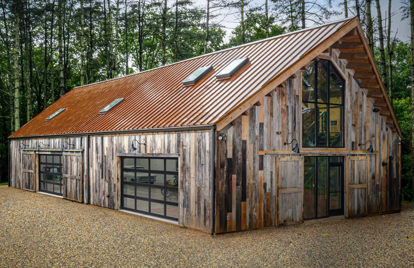 A barn with a garage door and windows.