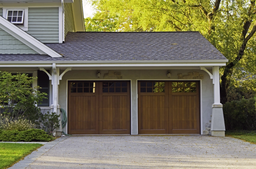 A garage door that is open and has two windows.